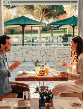 A Happy Couple Having Breakfast at Hotel Camiral 